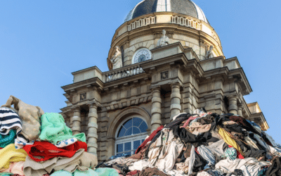 Collage de tas de vêtements devant le Sénat pour défendre la loi contre la fast fashion.